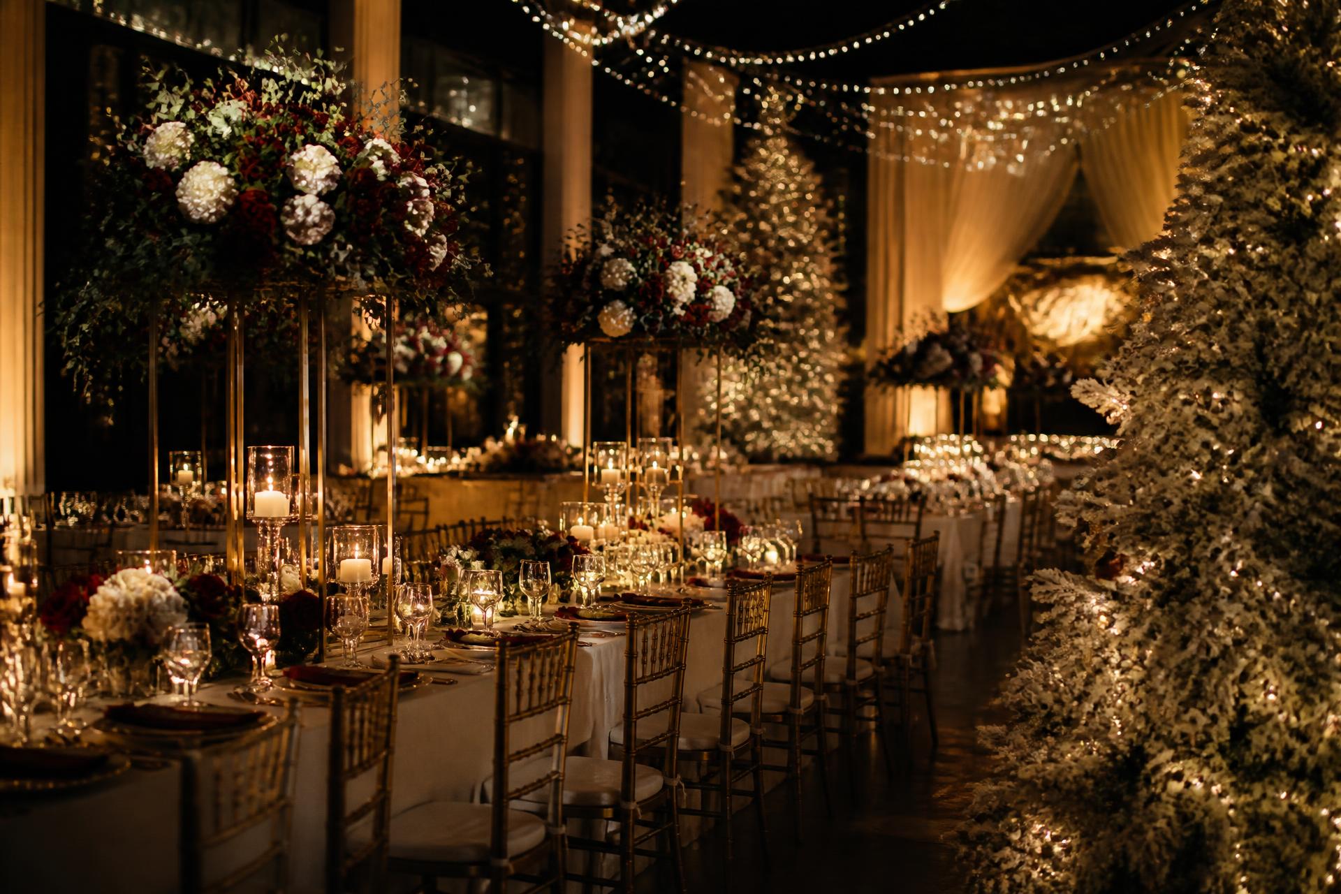 Luxury Christmas party with gold Chiavari chairs, candlelit tables and festive lighting